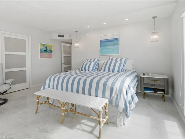 a bedroom with a bed and a chair