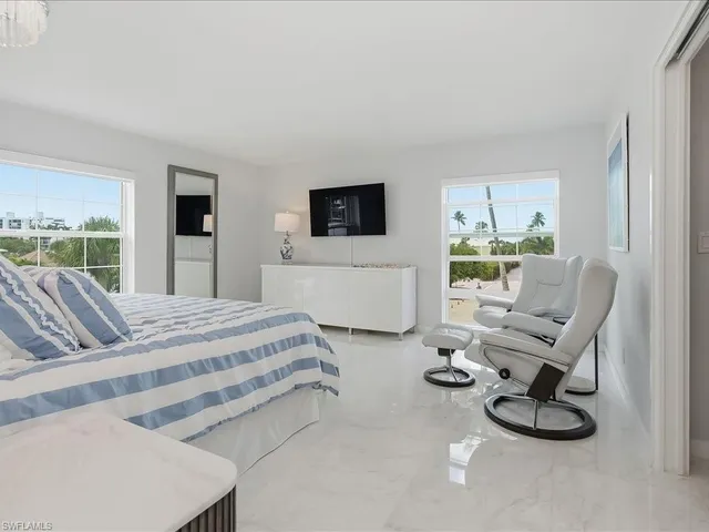 a bedroom with furniture and a flat screen tv