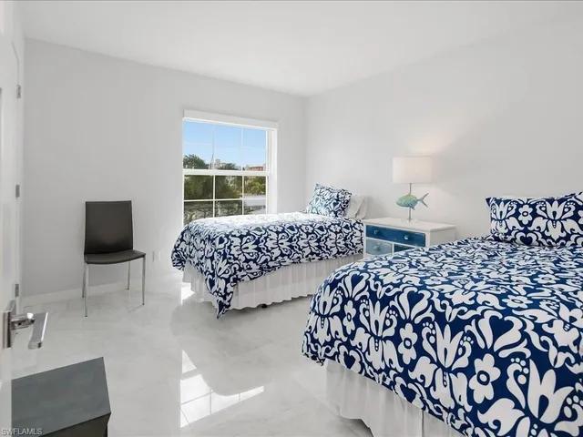 a bedroom with double bed and a window