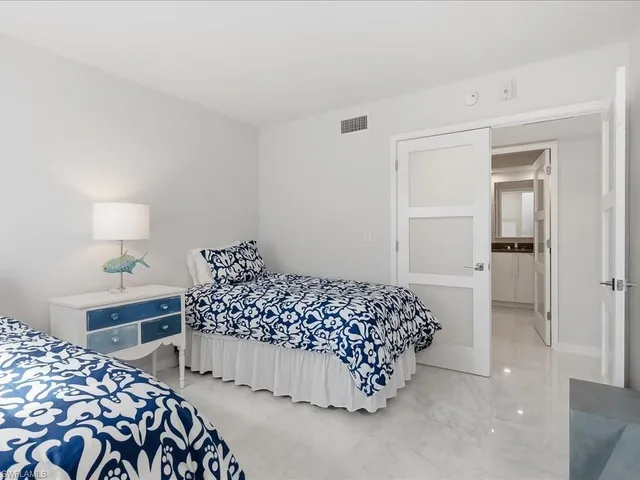 a bedroom with a bed and a lamp