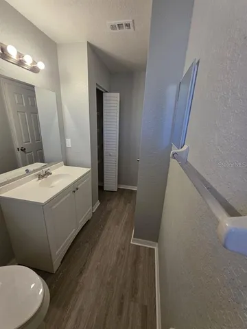 a bathroom with a sink a mirror and a toilet