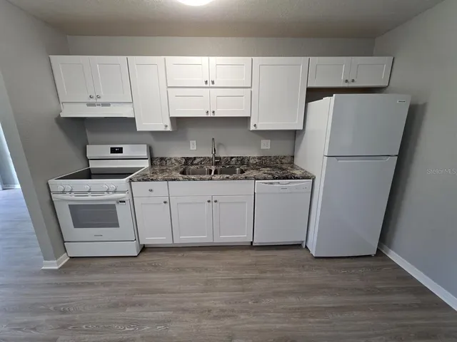 a white refrigerator freezer sitting inside of a kitchen