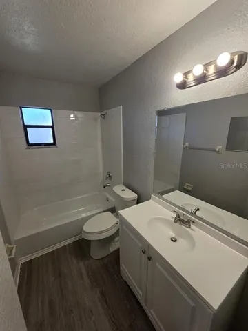 a bathroom with a double vanity sink toilet and a mirror