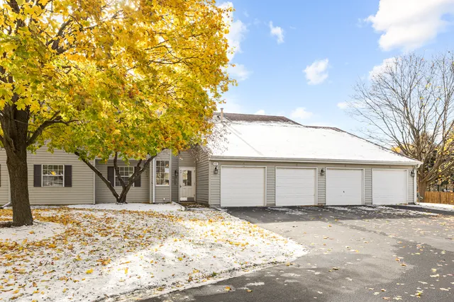 a front view of a house with a covered with snow