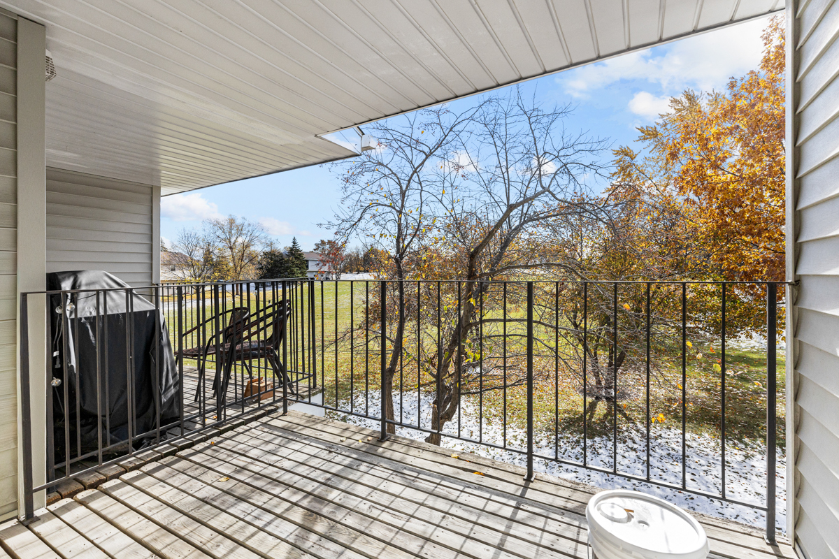 40 South Victoria Lane, Unit G Streamwood, IL 60107 - Photo 16 of 22 a view of a balcony with wooden fence and floor to ceiling window
