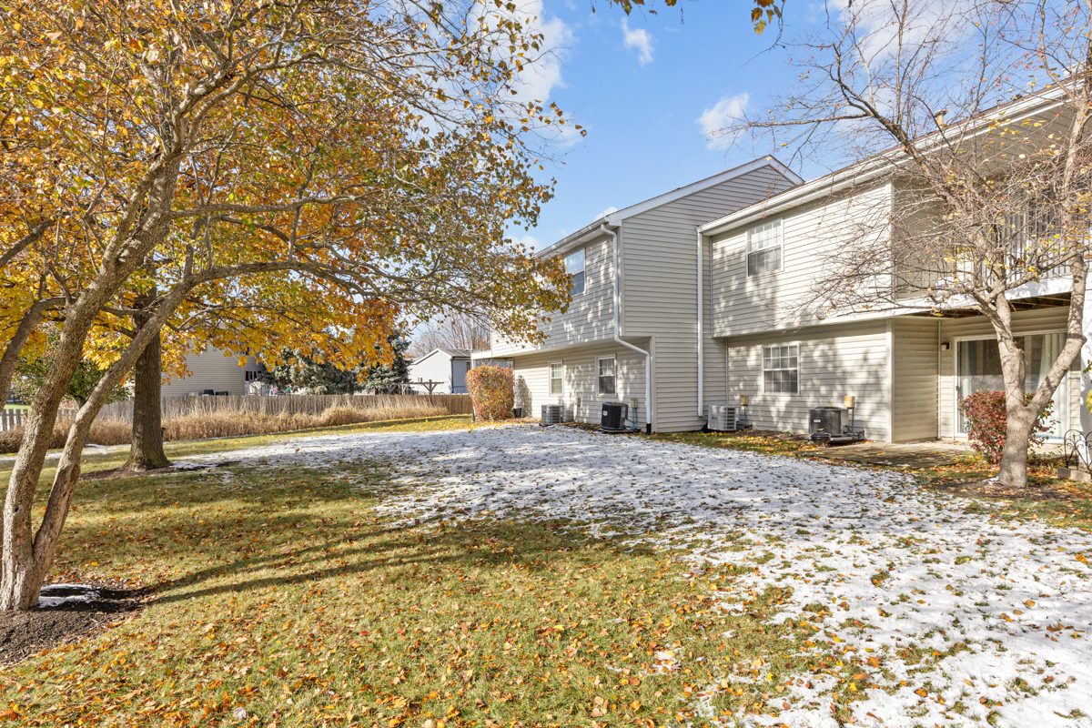 40 South Victoria Lane, Unit G Streamwood, IL 60107 - Photo 19 of 22 a view of a house with a yard and large tree