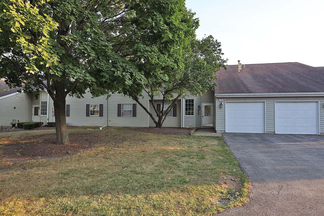 40 South Victoria Lane, Unit G Streamwood, IL 60107 - Photo 22 of 22 a front view of a house with a yard and garage