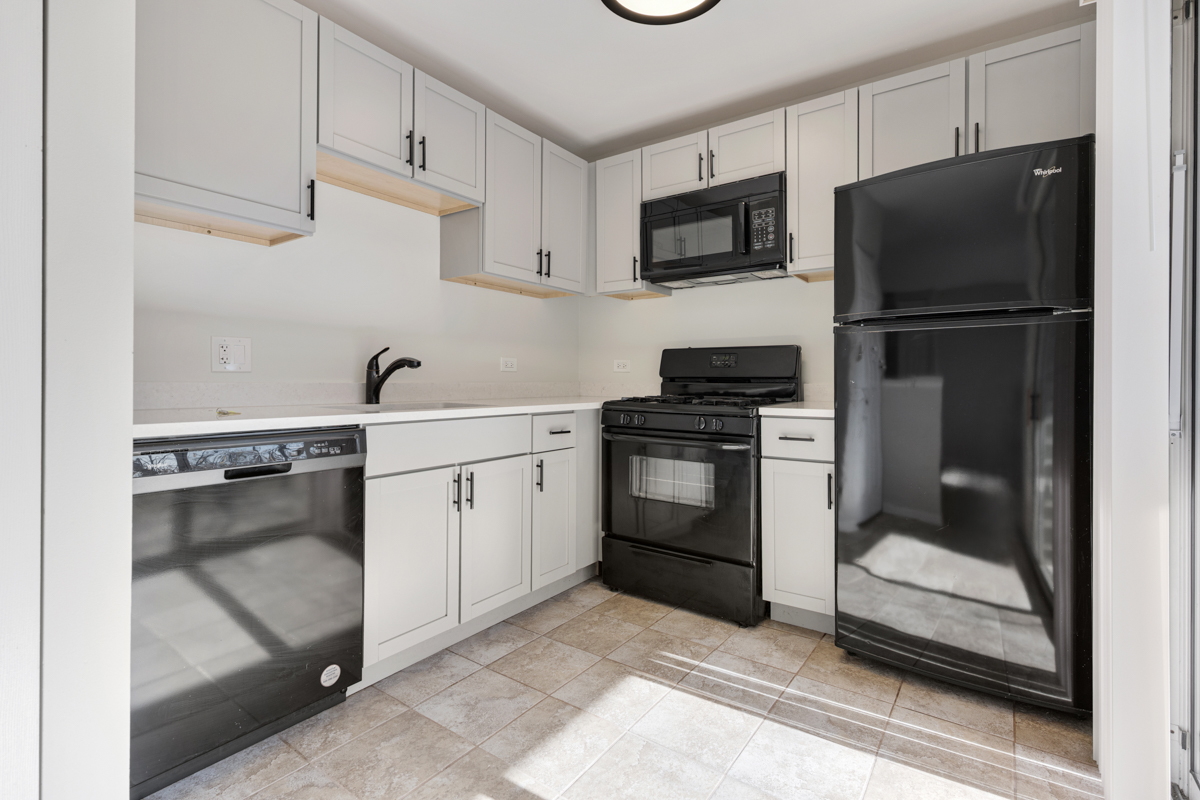 40 South Victoria Lane, Unit G Streamwood, IL 60107 - Photo 5 of 22 a kitchen with a sink appliances and cabinets