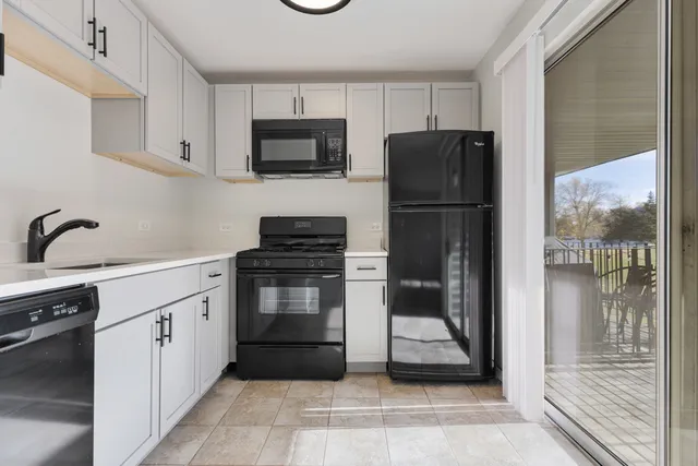 a kitchen with a refrigerator and a sink