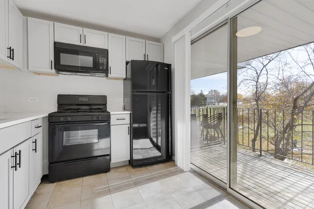 a kitchen with a refrigerator stove and microwave