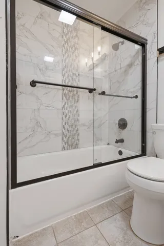 a bathroom with a shower and a toilet