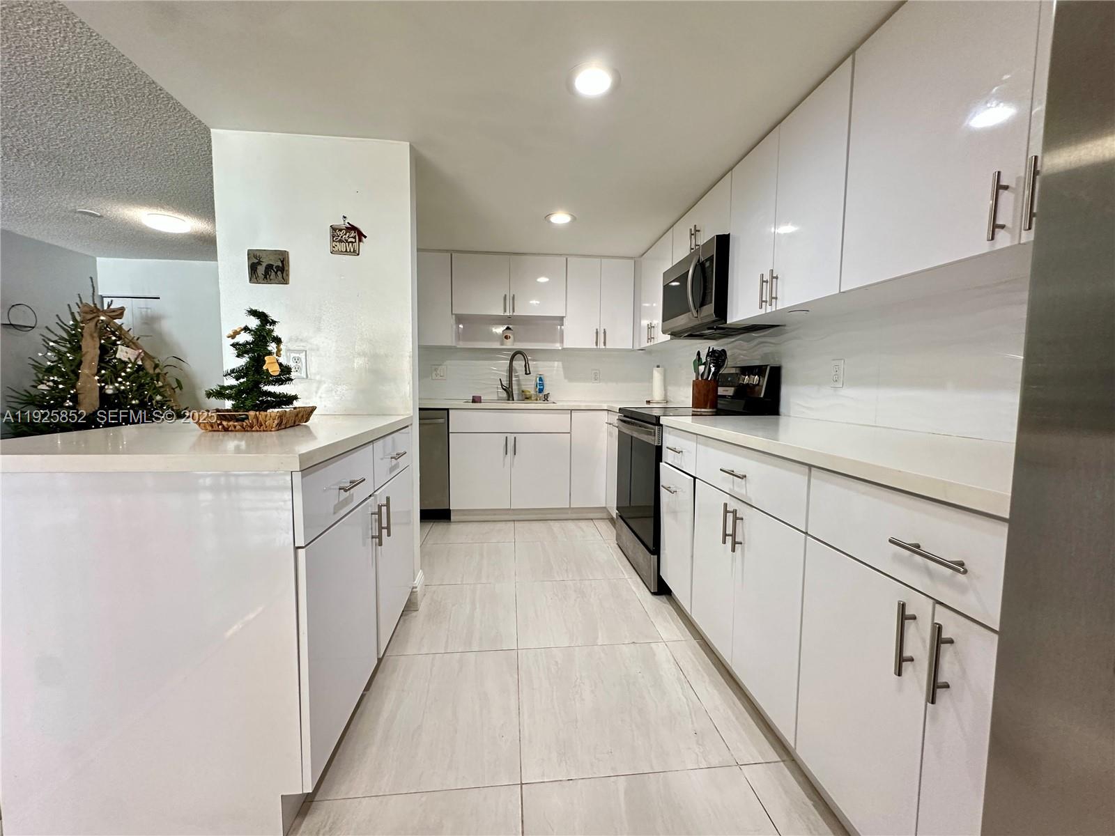 8091 Northwest 12th Street, Unit A Margate, FL 33063 - Photo 11 of 70 a kitchen with stainless steel appliances kitchen island granite countertop a sink and cabinets