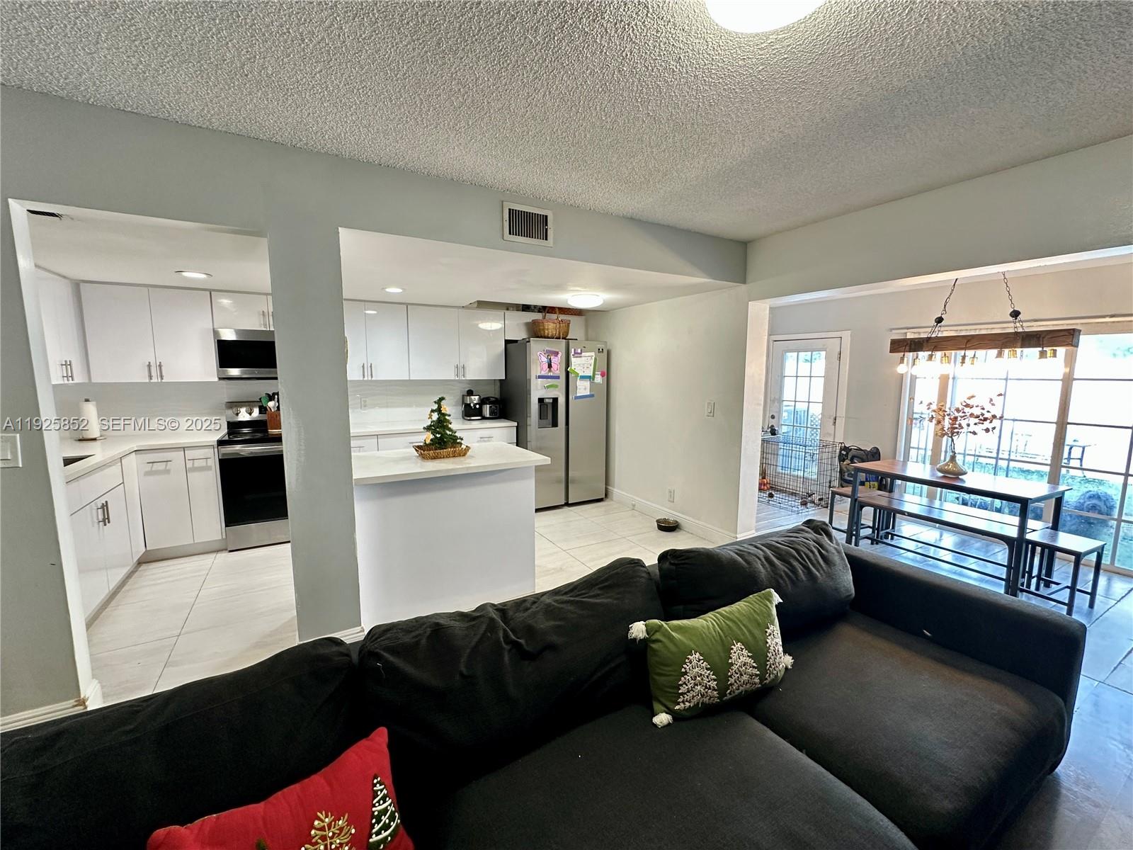 8091 Northwest 12th Street, Unit A Margate, FL 33063 - Photo 13 of 70 a living room with furniture and a large window