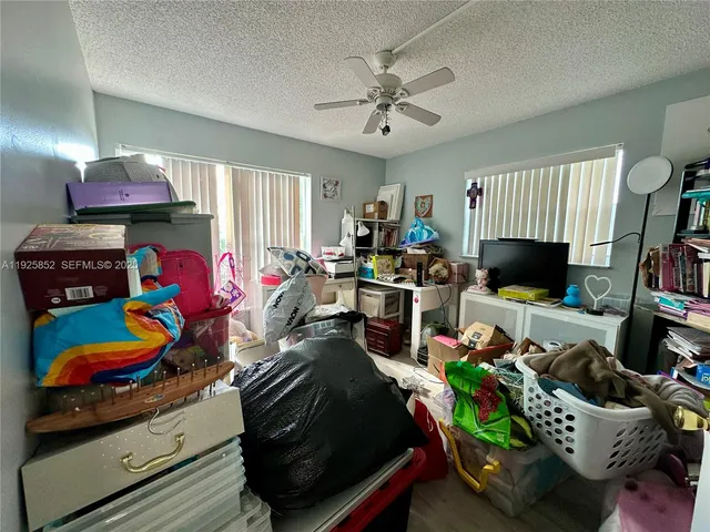 a living room filled with furniture and a potted plant