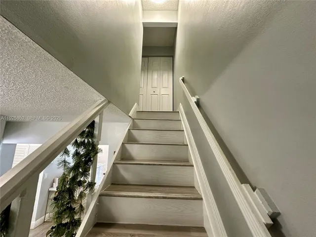 a bathroom with a sink vanity mirror and toilet