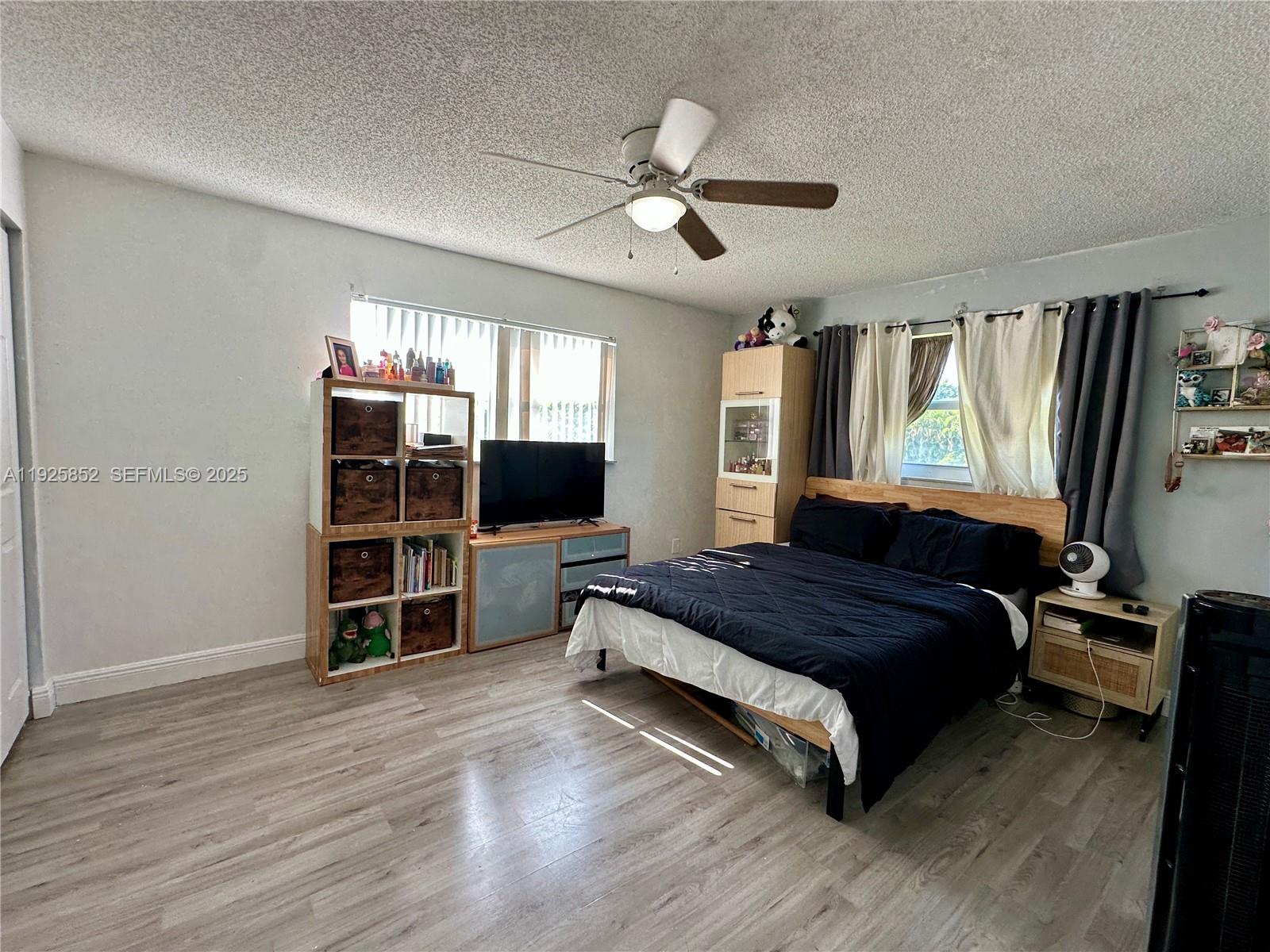 8091 Northwest 12th Street, Unit A Margate, FL 33063 - Photo 28 of 70 a spacious bedroom with a bed and a flat screen television