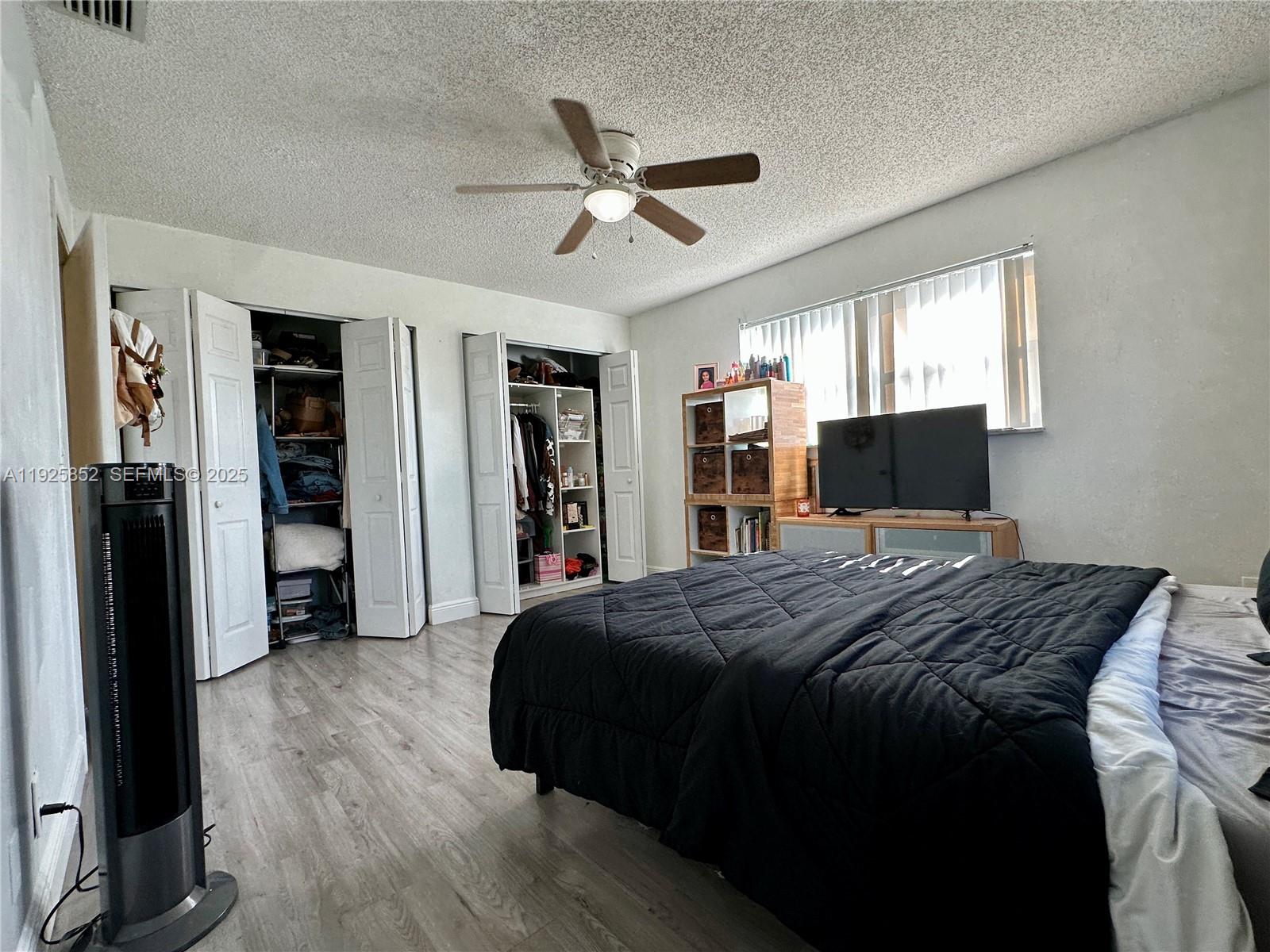 8091 Northwest 12th Street, Unit A Margate, FL 33063 - Photo 30 of 70 a bed sitting in a bedroom next to a window