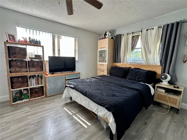 a view of a livingroom to closet and a mirror