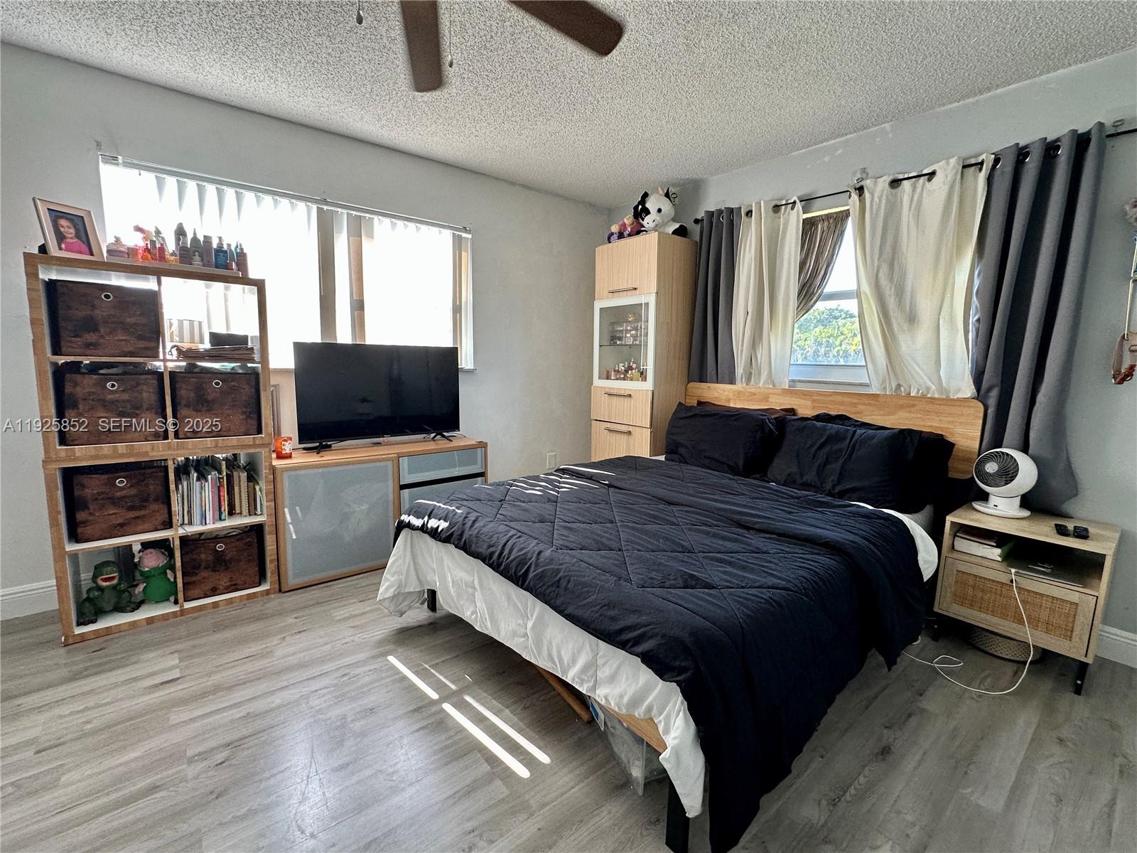 8091 Northwest 12th Street, Unit A Margate, FL 33063 - Photo 31 of 70 a bedroom with a bed television on desk and a window