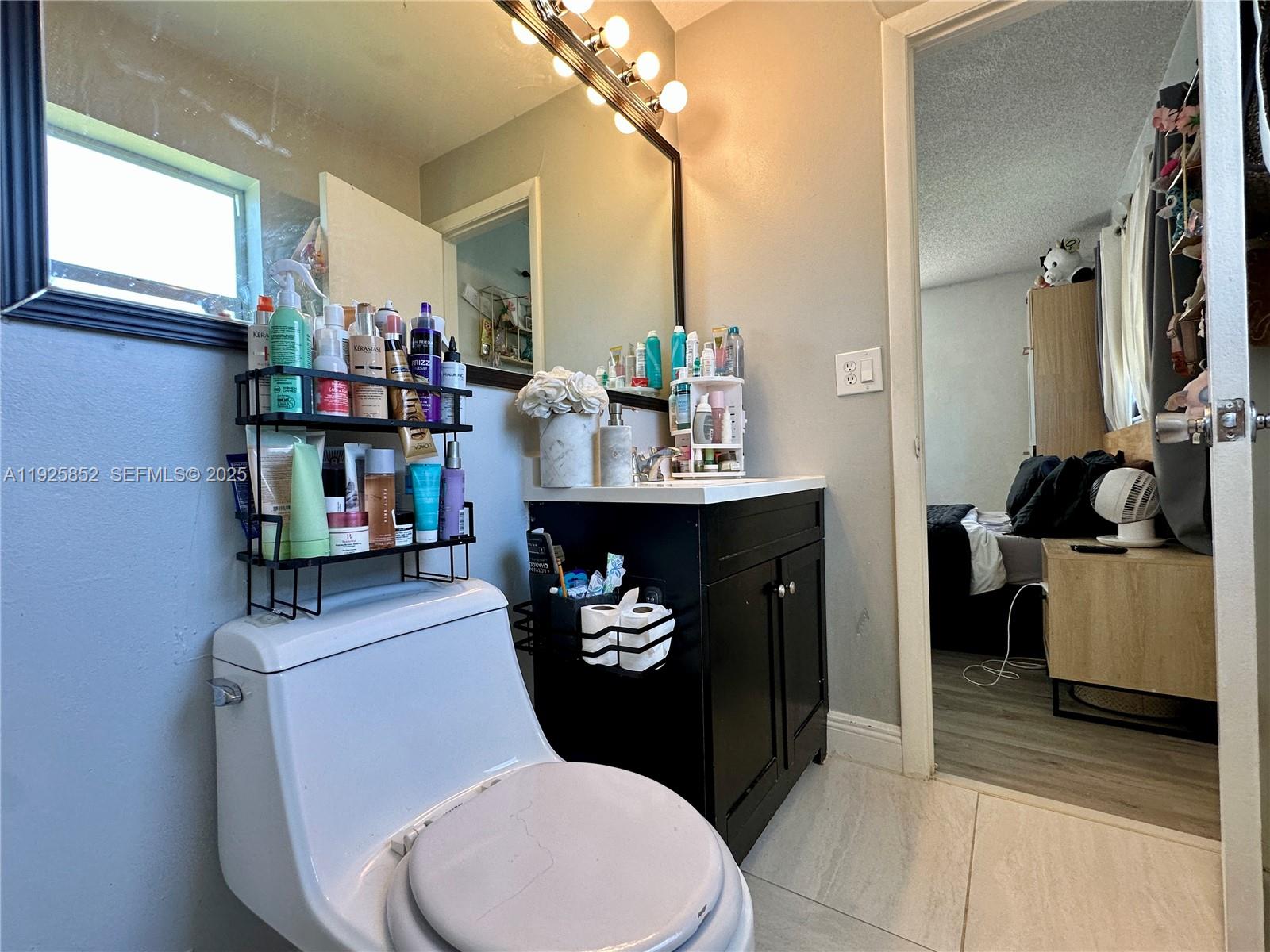8091 Northwest 12th Street, Unit A Margate, FL 33063 - Photo 33 of 70 a bathroom with a sink toilet and a mirror