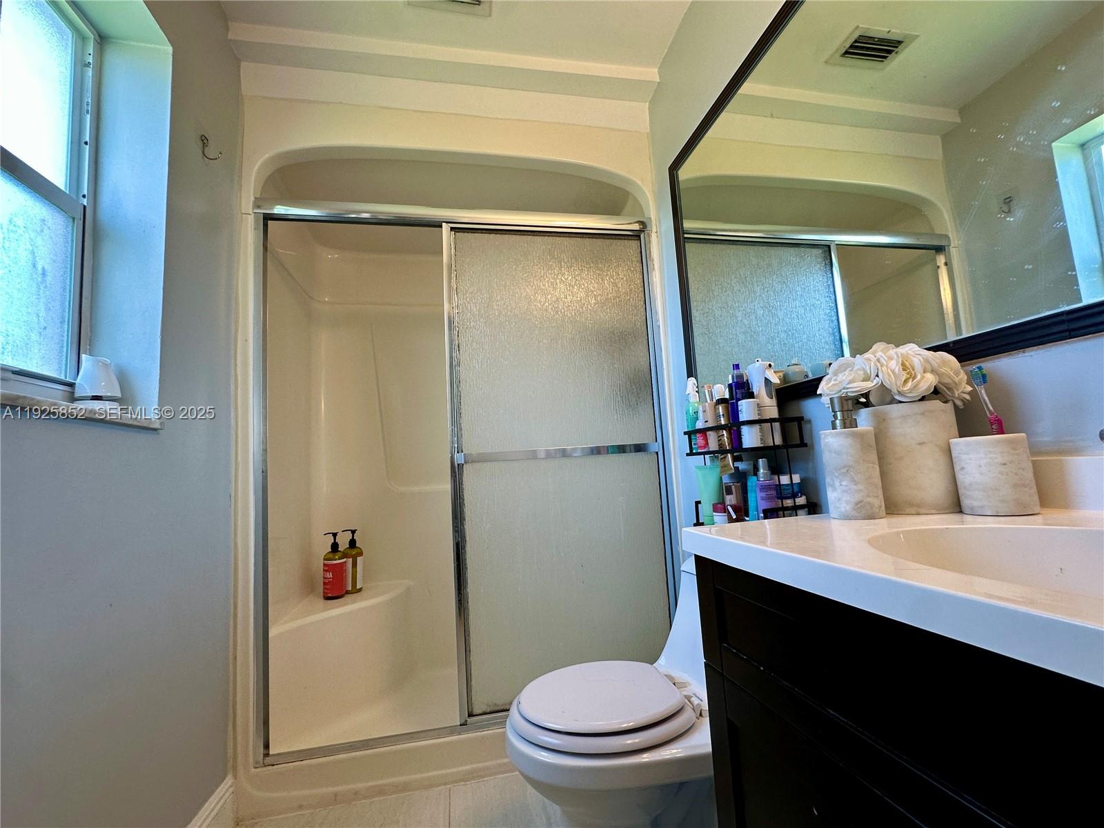 8091 Northwest 12th Street, Unit A Margate, FL 33063 - Photo 35 of 70 a bathroom with a sink a toilet and shower