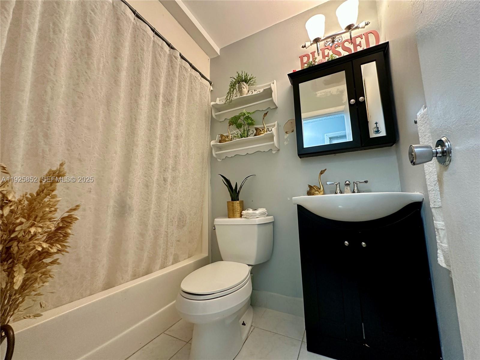 8091 Northwest 12th Street, Unit A Margate, FL 33063 - Photo 36 of 70 a bathroom with a sink vanity mirror and toilet