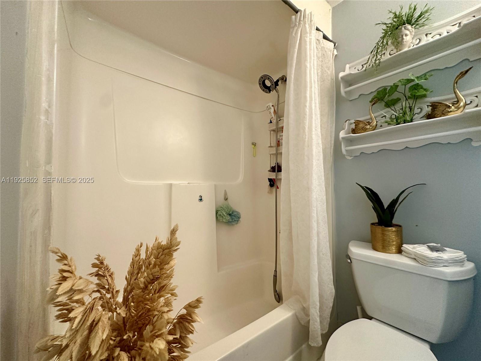 8091 Northwest 12th Street, Unit A Margate, FL 33063 - Photo 37 of 70 a bathroom with a toilet and a shower