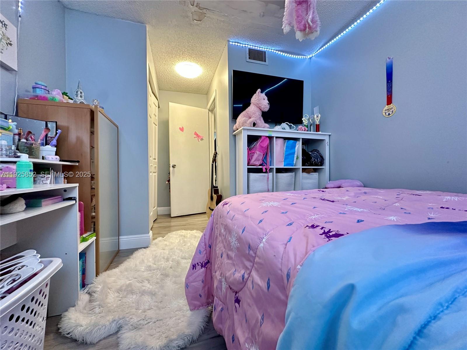 8091 Northwest 12th Street, Unit A Margate, FL 33063 - Photo 38 of 70 a bed room with a bed and a television