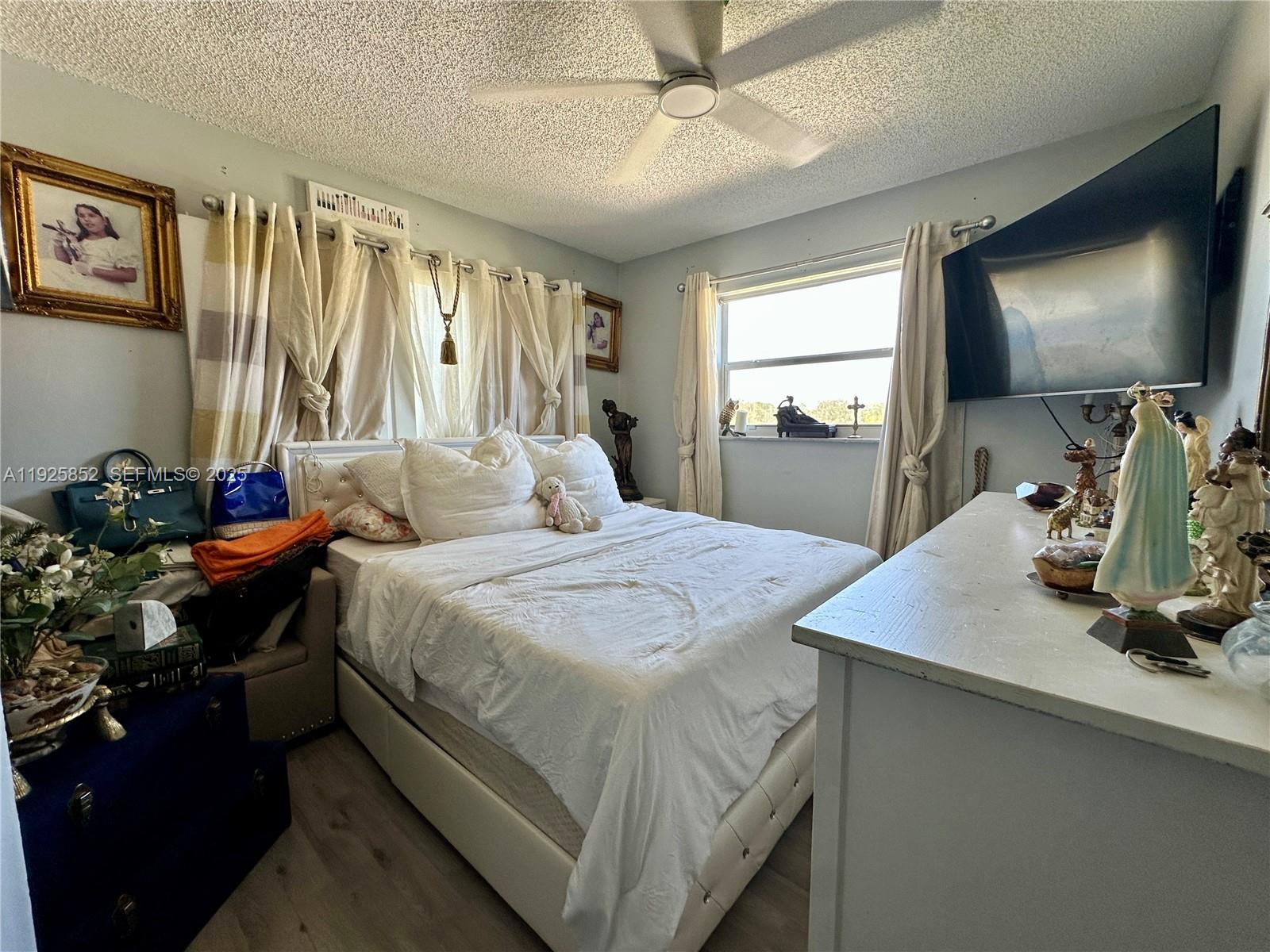 8091 Northwest 12th Street, Unit A Margate, FL 33063 - Photo 43 of 70 a bedroom with a bed and a flat screen tv