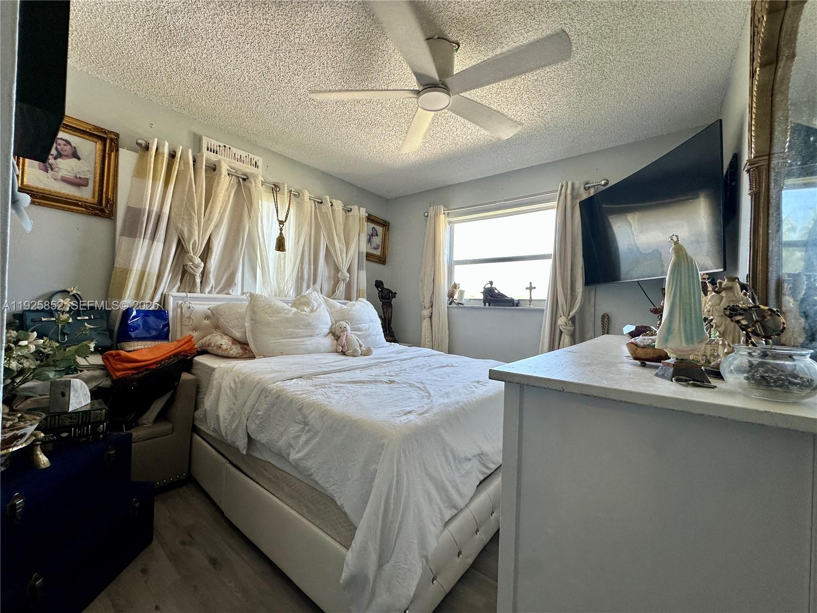 8091 Northwest 12th Street, Unit A Margate, FL 33063 - Photo 44 of 70 a bedroom with a bed and a large mirror on the dresser