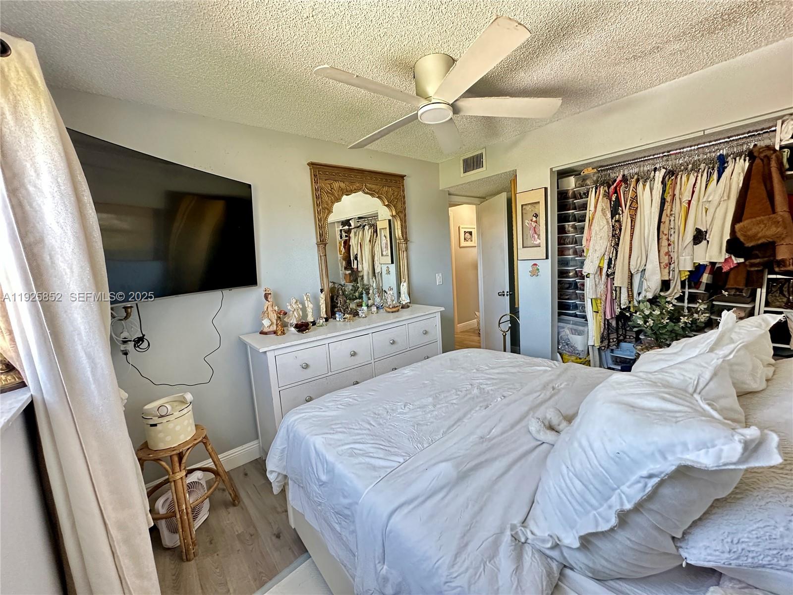 8091 Northwest 12th Street, Unit A Margate, FL 33063 - Photo 47 of 70 a bedroom with a bed and a flat tv screen on dresser