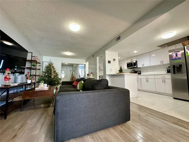 a kitchen with stainless steel appliances kitchen island granite countertop a sink and cabinets