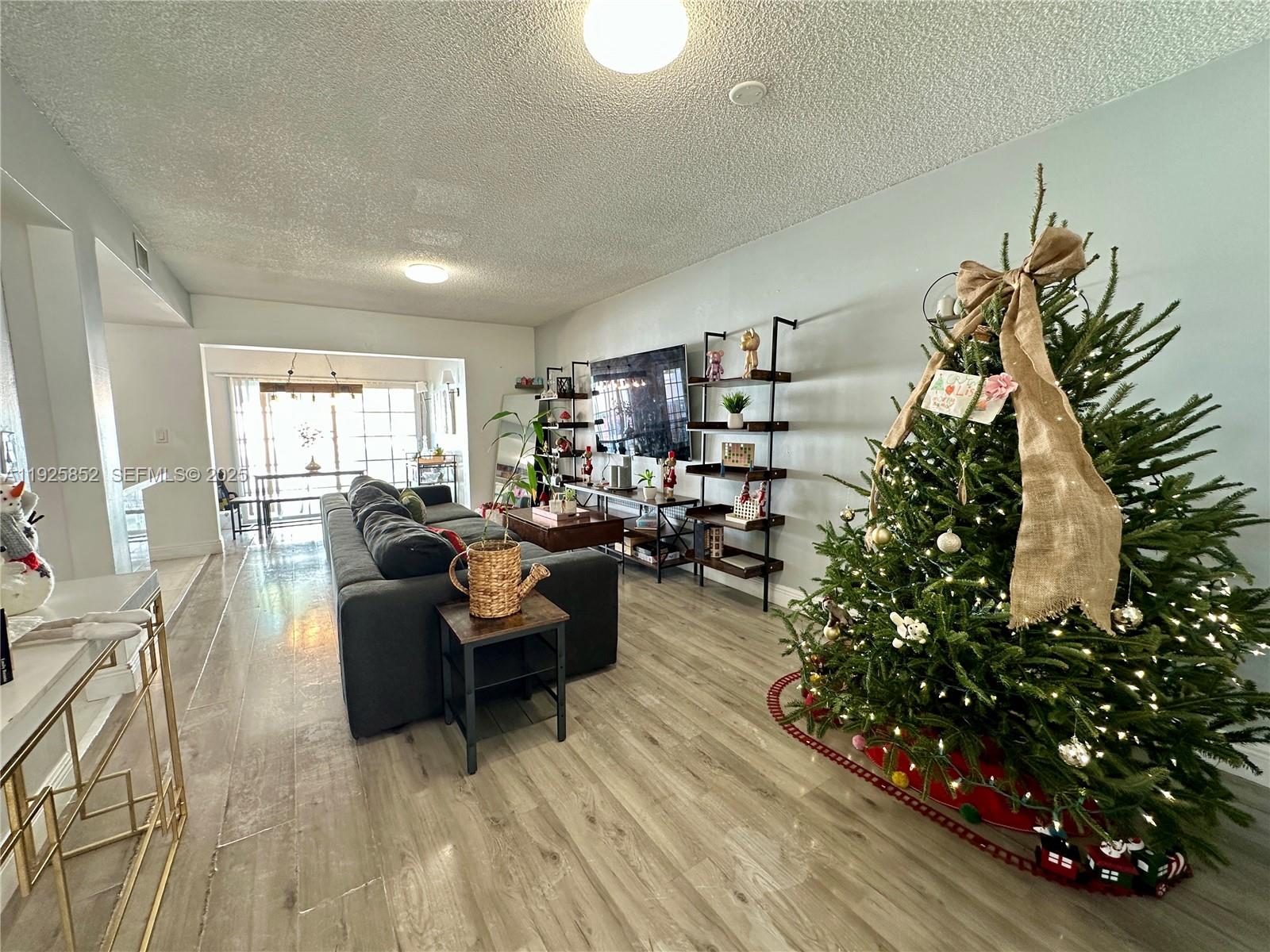 8091 Northwest 12th Street, Unit A Margate, FL 33063 - Photo 10 of 70 a living room with furniture and a potted plant