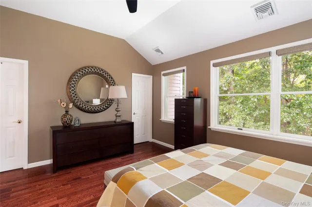 a room with a bed and a mirror