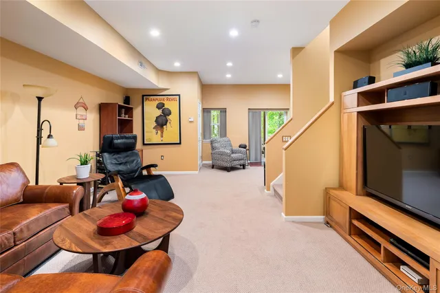 a living room with furniture and stairs
