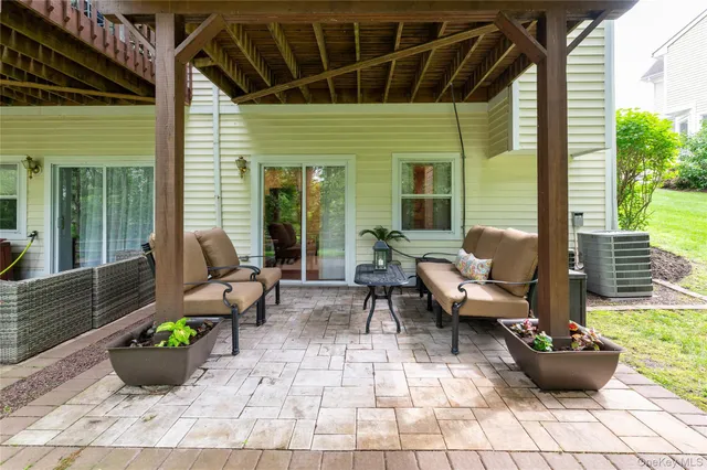 a view of a patio with couches and potted plants