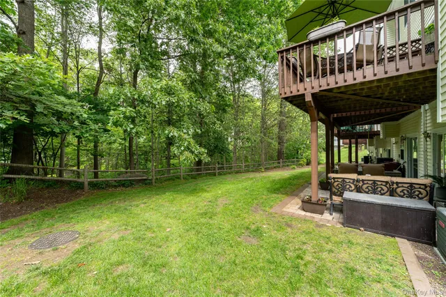 a view of a backyard with a deck and a garden