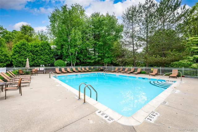 a view of a swimming pool with chairs