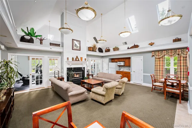 a living room with furniture fireplace and a large window