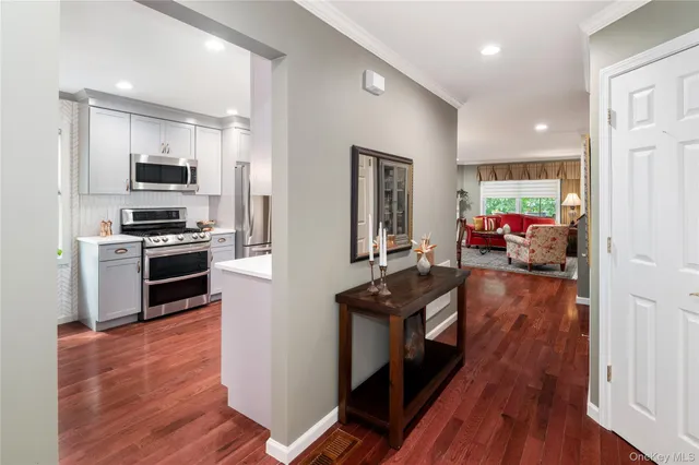 a kitchen with a refrigerator and a stove top oven