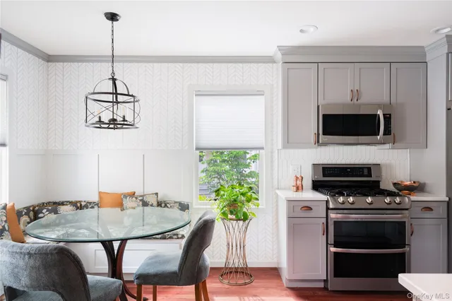 a kitchen with stainless steel appliances kitchen island granite countertop a stove a sink and a microwave