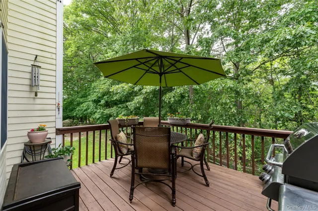 a view of a chair and table on the deck