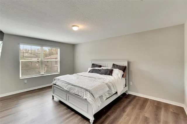 a bathroom with a granite countertop shower sink and mirror