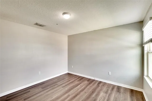 an aerial view of residential houses with outdoor space and parking
