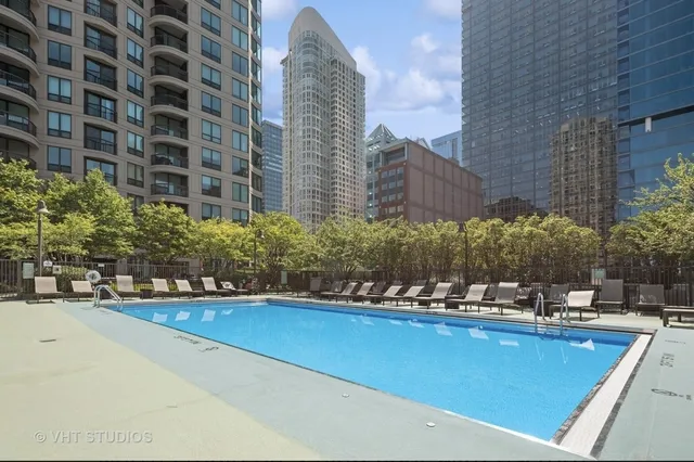 a view of a swimming pool with outdoor seating