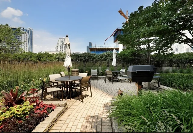 a view of a chairs and table in patio with a lake view