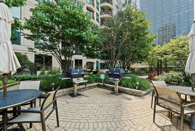 a view of patio with table and chairs and potted plants