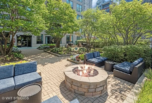 a view of a patio with couches table and chairs and potted plants