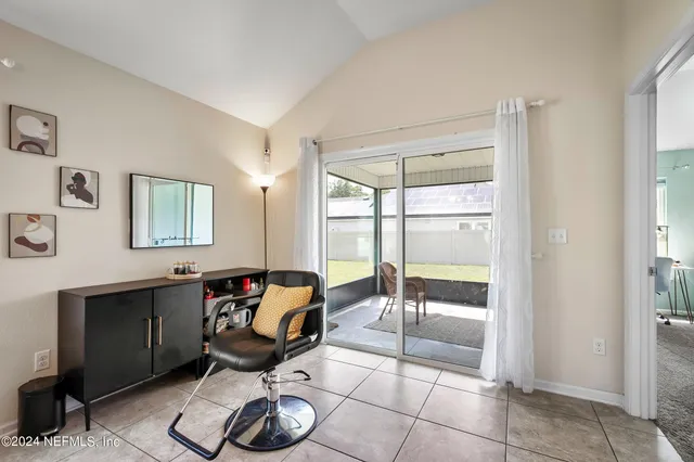 a living room with furniture and a floor to ceiling window