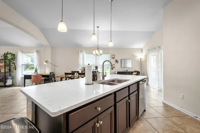 a kitchen with a stove a sink a center island and a cabinets